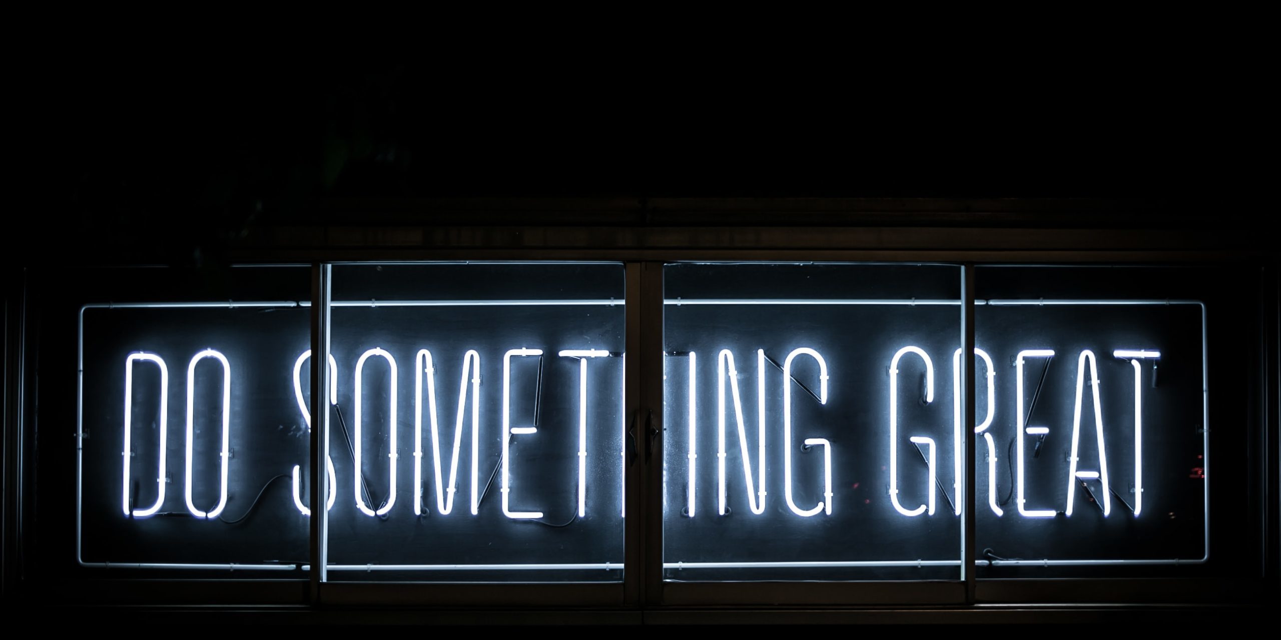 neon sign reading "do something great"